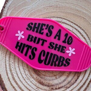 She's A 10 But She Hits Curbs Motel Keychain